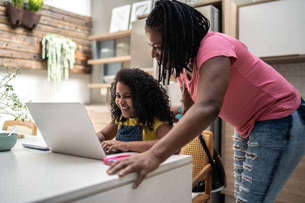 istock Mother helping daughter with homework 1304451039