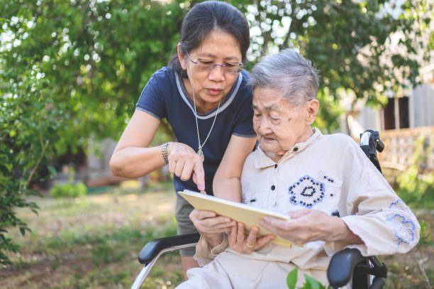 istock Old elderly disabled asian on wheelchair using digital tablet consulting with Doctor having video call ,video conference with experienced medical worker from home 1304459229