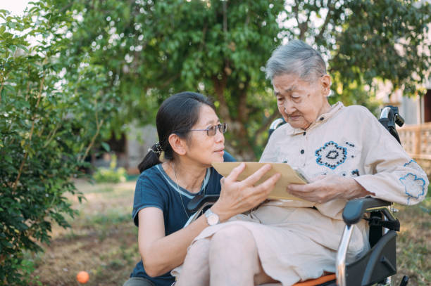 istock Old elderly disabled asian on wheelchair using digital tablet consulting with Doctor having video call ,video conference with experienced medical worker from home 1304459235