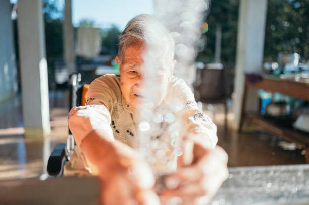 istock Asian elder disability on wheelchair washing her hand in kitchen 1304459242