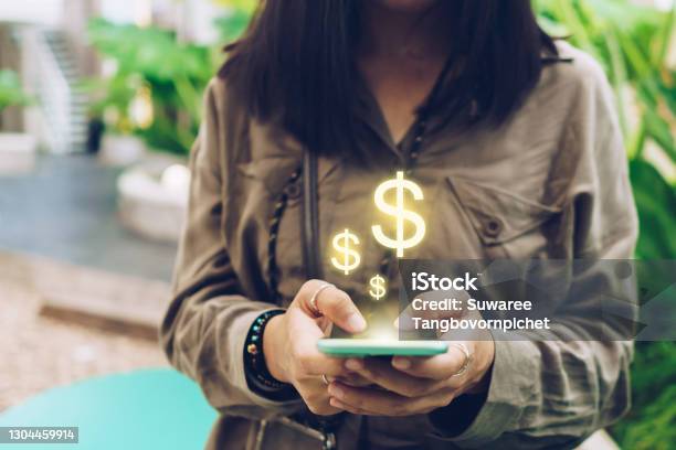 Woman Use Gadget Mobile Smartphone Earn Money Online With Dollar Icon Pop Up Business Fintech Technology On Smartphone Concept Stock Photo - Download Image Now