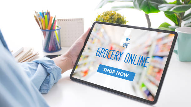 istock Hand holding digital tablet with grocery online shopping application on device screen over blur supermarket background, business and technology, lifestyle concept 1304460905