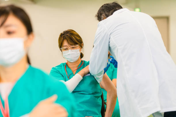 istock Group of frontline healthcare workers getting vaccinated in vaccination center 1304461445