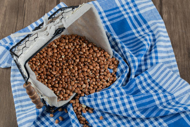 istock Basket of red beans on striped tablecloth 1304461616