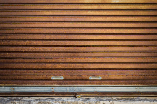 Rolling door or old rolling door, large, brown, rusted And with a gulk lock