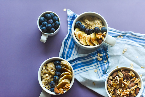 Oatmeal in a cup decorated with blueberries and bananas