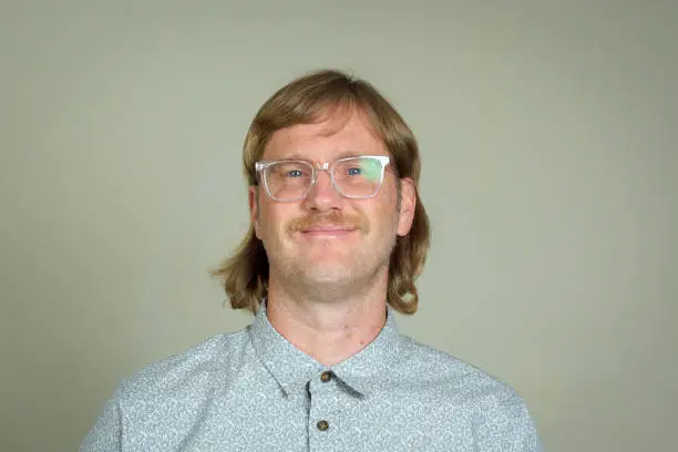 Happy man with mullet and glasses