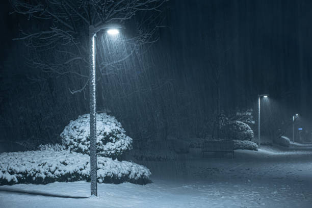 istock Snow falling with street lantern in the night 1304470796