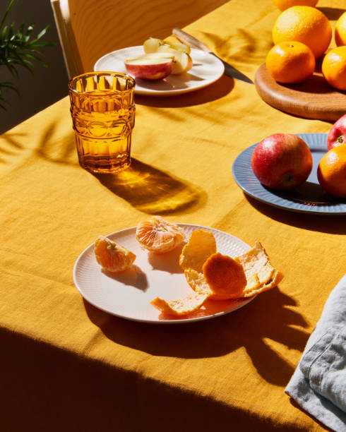 istock Food, breakfast with fruit. Table covering bright yellow linen tablecloth, sunlight deep hard shadow 1304472275