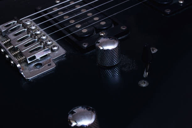 istock Switches on a black electric guitar closeup 1304473229