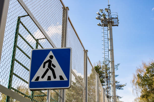 istock Tall modern lantern and crosswalk sign close up 1304473312