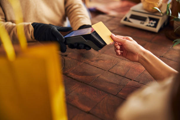 istock Young woman using credit card to pay for purchases 1304477043