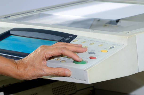 istock Business people press the start button at the copier. 1304477688