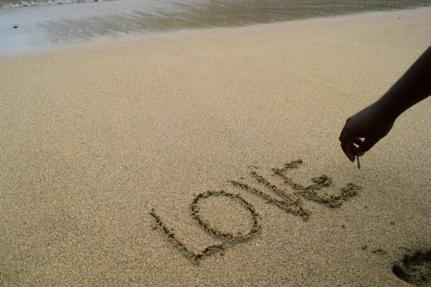istock Finish writing the word love on the beach sand 1304478485
