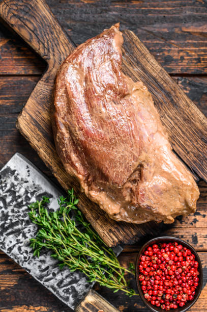 istock Marinated in mustard Marinate beef tri tip steak for bbq. Black background. Top view 1304478544