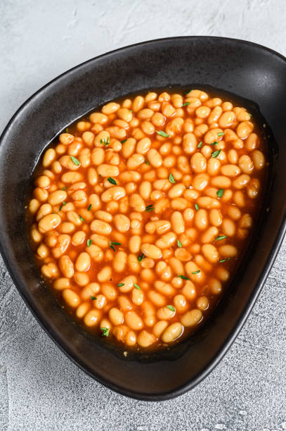 istock Baked beans in tomato sauce in a plate. White background. top view 1304482680