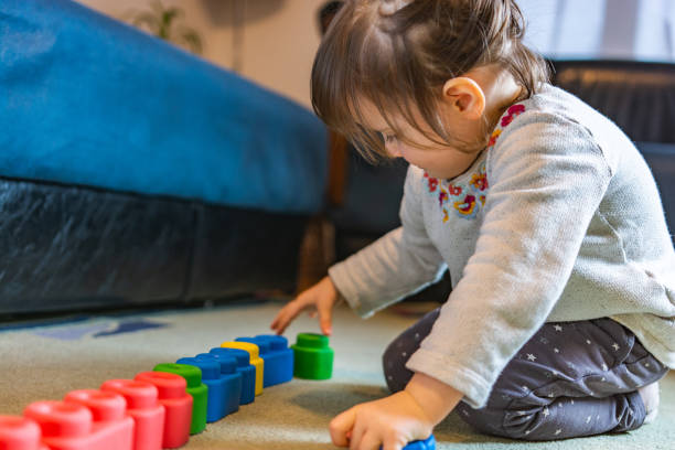 istock Girl playing with rubber blocks on the floor 1304482985