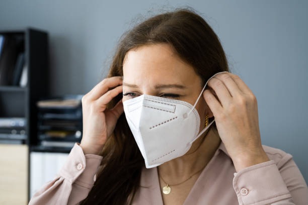 istock Woman Putting On Medical Face Mask 1304483732