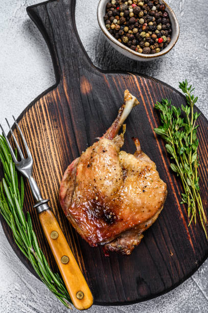 istock Fried duck confit leg baked poultry meat. White background. top view 1304484561