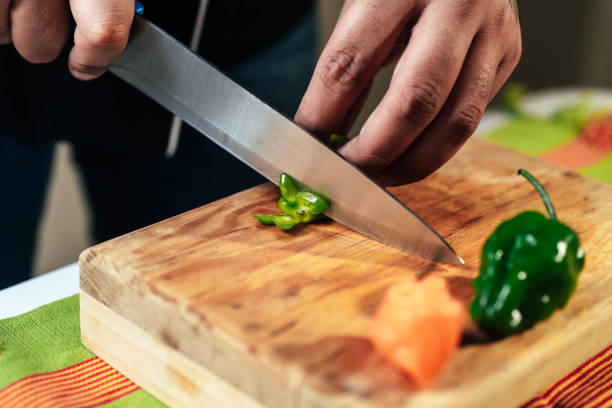 istock Chef cutting habanero on cutting board for mexican sauce 1304484639