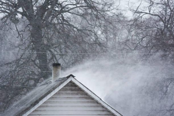 istock A strong blizzard blows snow from building roof 1304485352