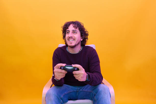 istock Young man playing video games 1304487457