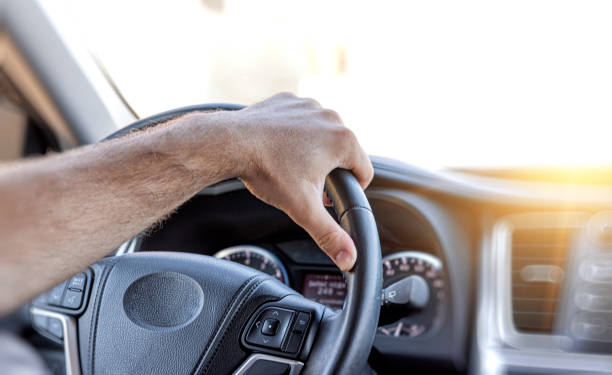 istock Driver keeps his hands on the steering wheel of the car. 1304487982