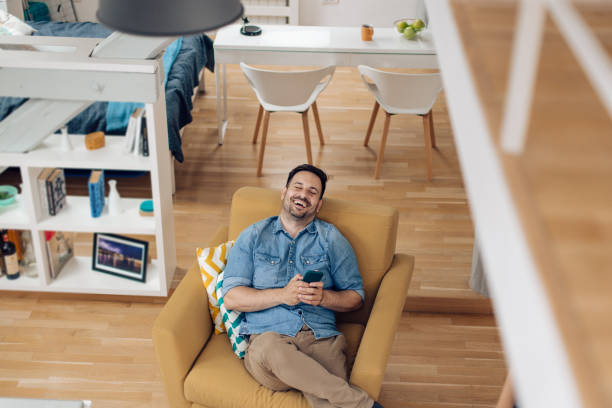 istock Young man enjoying at his house and texting with somebody 1304488064