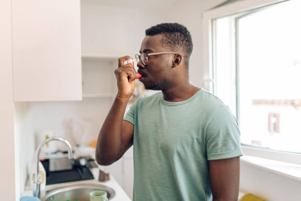 istock African American man using asthma inhaler at his kitchen 1304488213