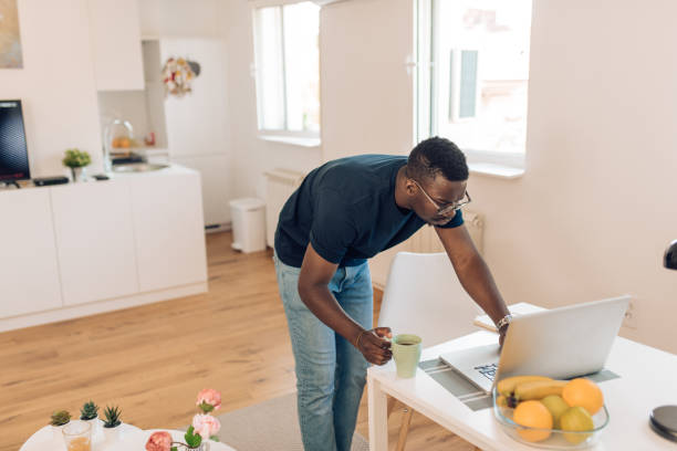 istock African-American freelancer  standing and working on his laptop 1304488251
