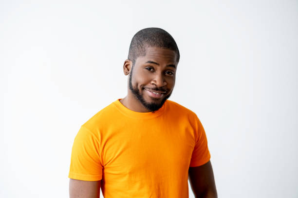 istock happy man portrait good news african guy orange 1304488310