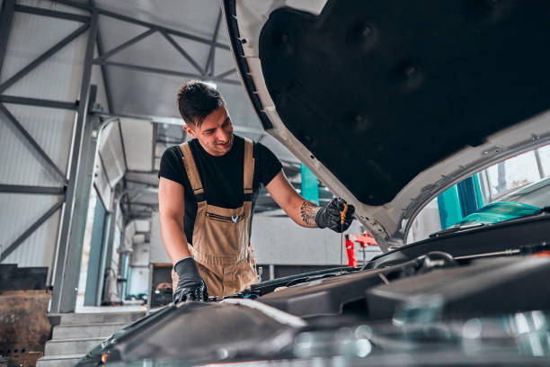 istock Mechanic checking oil level in a car workshop. 1304488706