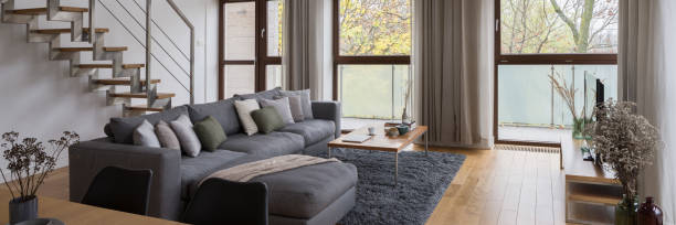 istock Elegant sofa in living room with stairs, panorama 1304491664