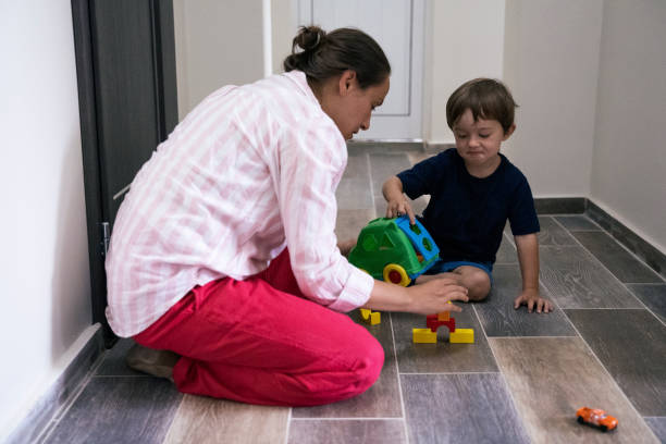 istock Mother and son playing at home with the constructor and a car during the COVID-19. 1304491745