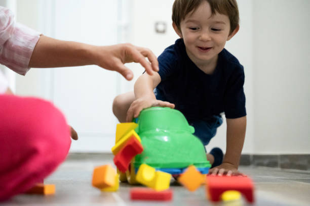 istock Mother and son playing at home with the constructor and a car during the COVID-19. 1304491759