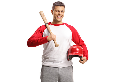 Handsome young man with a baseball bat and red helmet isolated on white background
