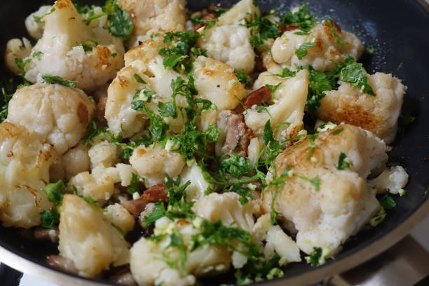 istock Cauliflower cooked with bacon, minced garlic and parsley 1304494511