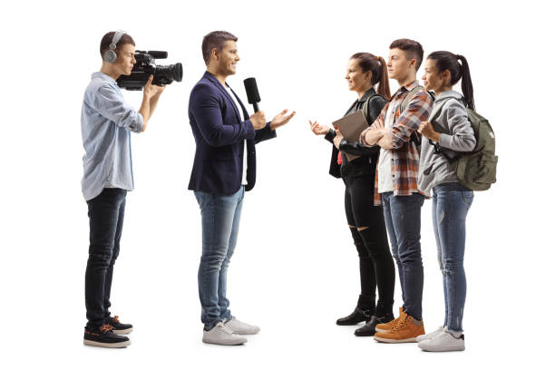 istock Cameraman and a reporter interviewing a group of students 1304496722