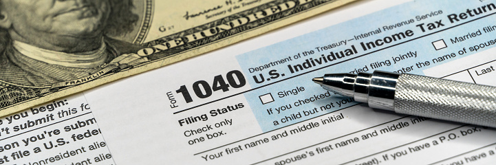 Tax form with pen and dollar banknote. document are mock-up. wide banner