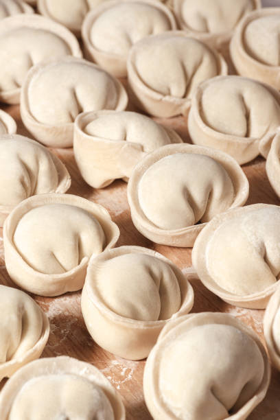 istock Fresh hand made dumplings ready to cooking on board 1304498804