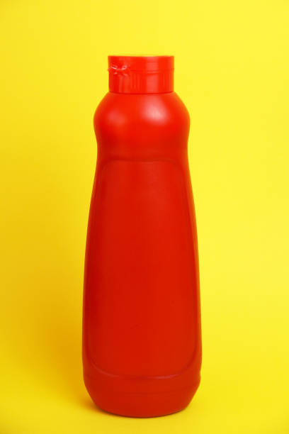 istock red plastic bottle with ketchup on yellow background 1304498975