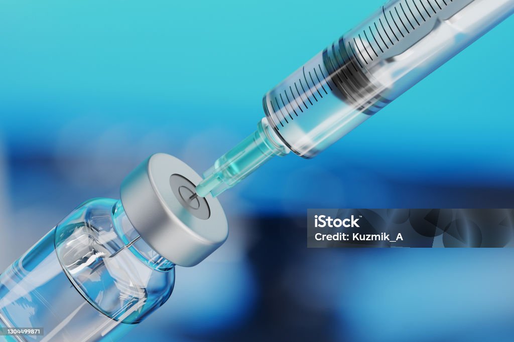 Medical disposable syringe for vaccine injection and glass vial. Medical disposable syringe for vaccine injection and glass vial on blue blur background. Vaccination Stock Photo