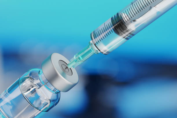 Medical disposable syringe for vaccine injection and glass vial. Medical disposable syringe for vaccine injection and glass vial on blue blur background. injecting stock pictures, royalty-free photos & images