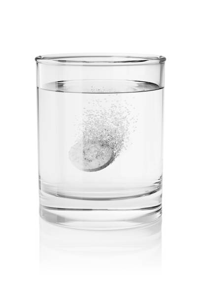 Effervescent tablet in a glass of water isolated. 3D rendering illustration.