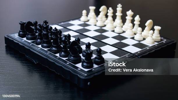 Spaced Chess On A Black Wooden Background Stock Photo - Download Image Now - Backgrounds, Belarus, Black Color