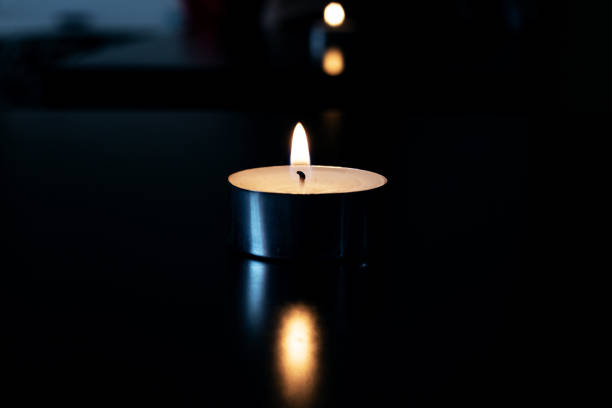 istock Flame of a small candle in the dark 1304500219