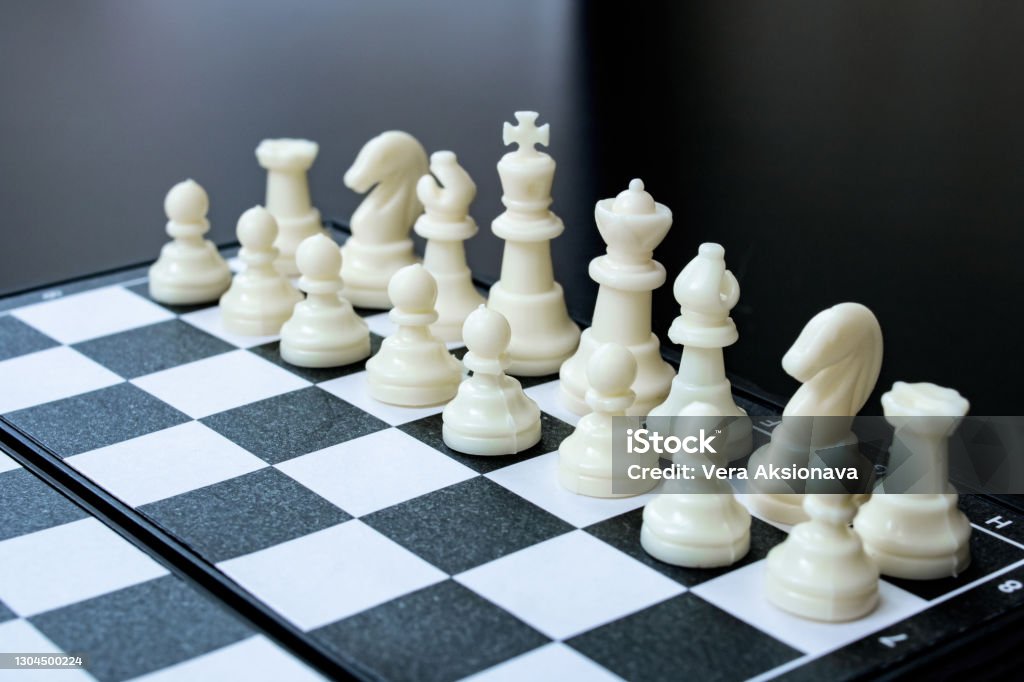 Spaced chess on a black wooden background Spaced chess on a black wooden background close up Backgrounds Stock Photo