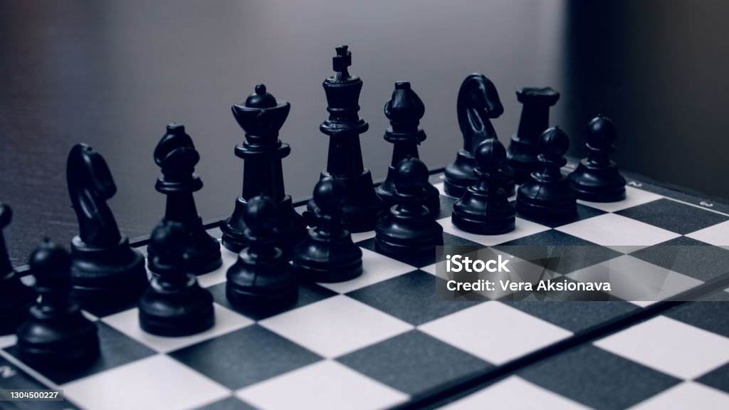Spaced chess on a black wooden background Spaced chess on a black wooden background close up Backgrounds Stock Photo