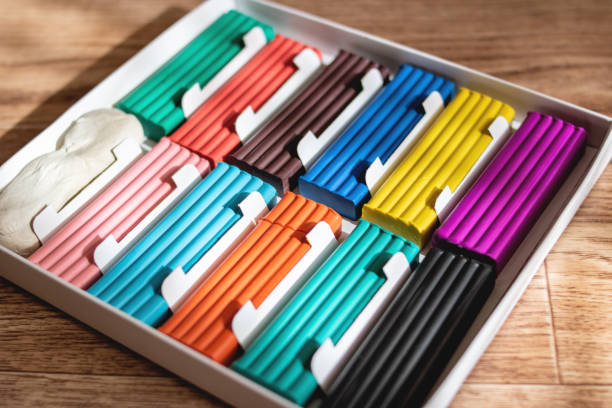 istock Multicolored plasticine on a wooden table closeup 1304500272
