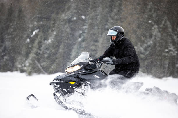 istock Man having fun speeding with a snowmobile through the powder snow 1304500453